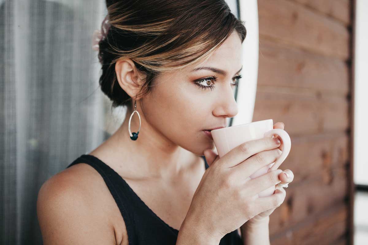 Photo of woman sipping coffee