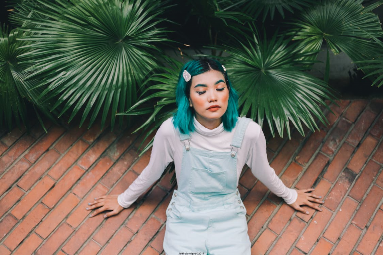 lady with dyed hair sitting on ground